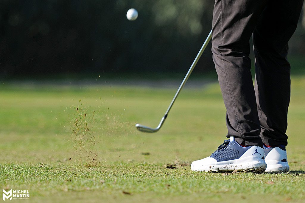Detalle de los pies y el palo en un approach de Ricky Cabello Golf